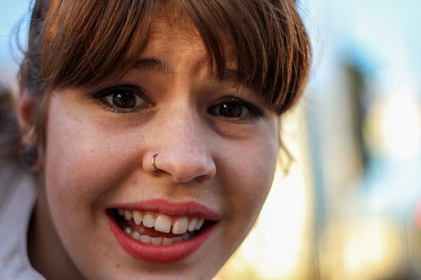 girl with a ring in her nose and showing gaps in her front teeth